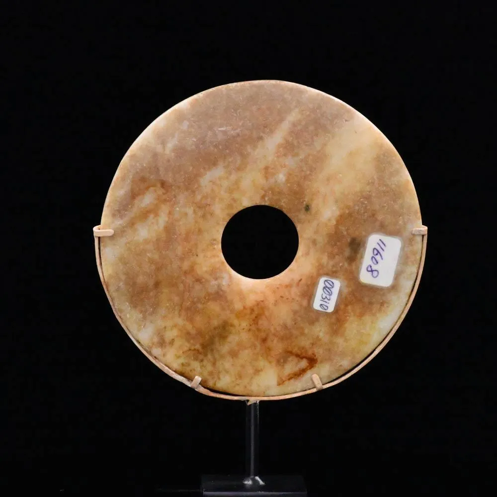 A Chinese Mottled Nephrite Jade Bi Disc, Late Neolithic Period, ca. 3000 - 2000 BCE