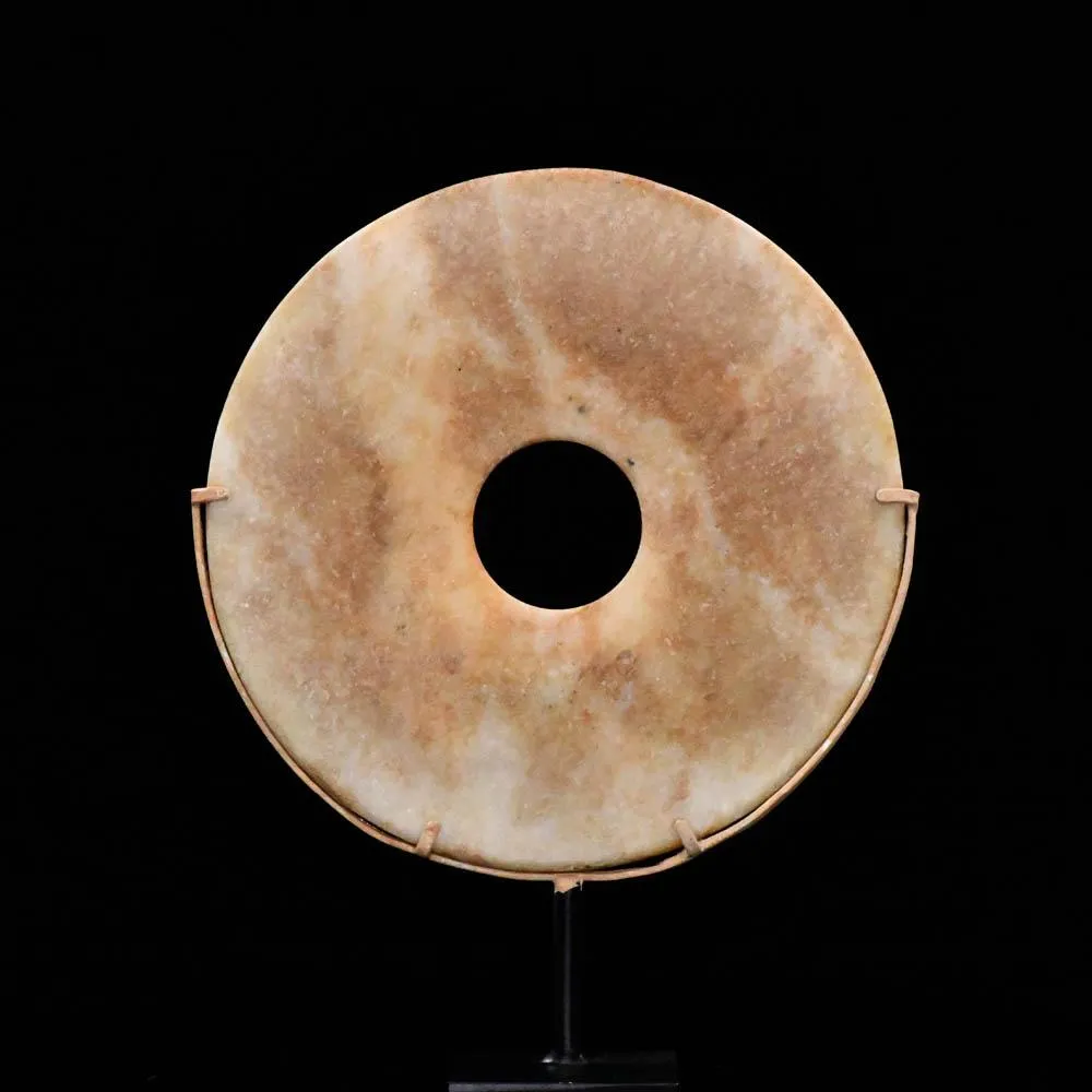 A Chinese Mottled Nephrite Jade Bi Disc, Late Neolithic Period, ca. 3000 - 2000 BCE